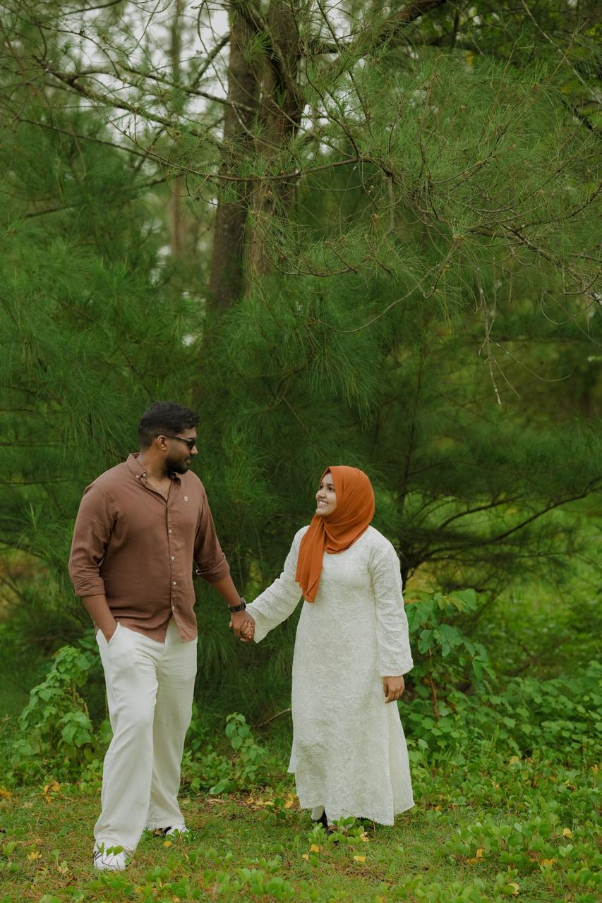Mohammed and Rinsha standing side by side in the forest